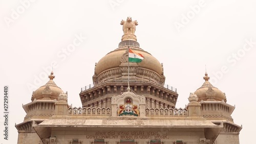 Waving Indian flag above the Vidhana Soudha or parliament or legislative assembly of Karnataka at Bangalore, India. photo