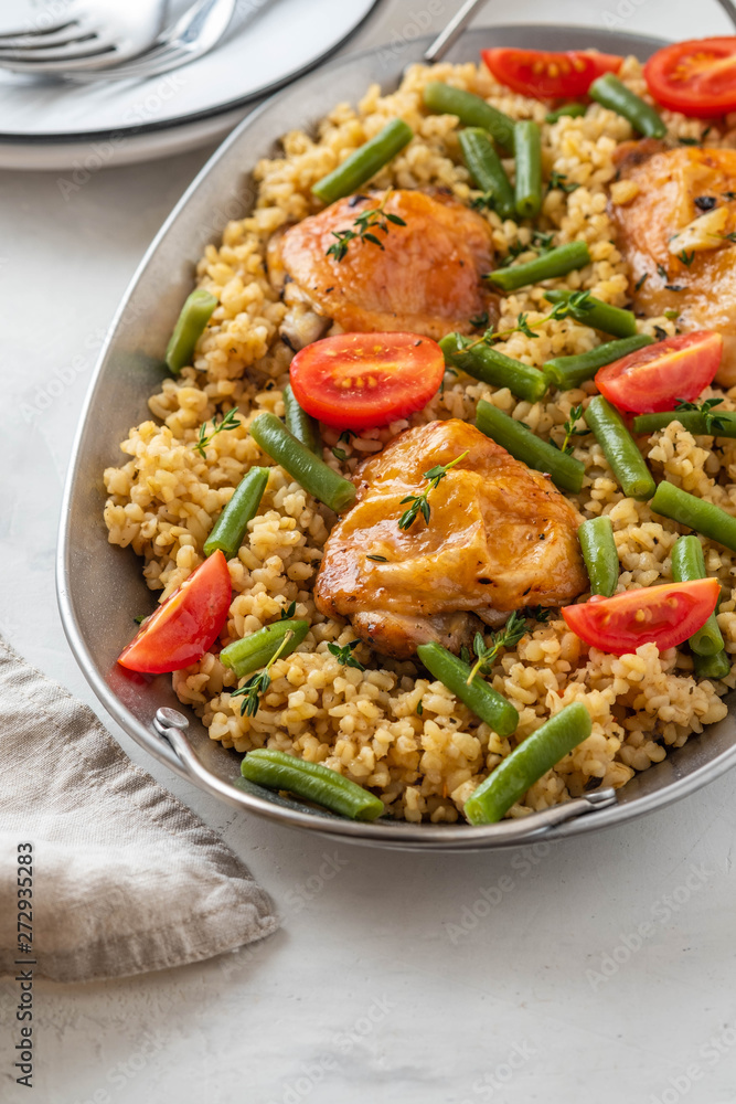 Grilled chicken thighs with bulgur, asparagus beans and tomatoes. Delicious lunch. Grilled chicken thighs with bulgur, asparagus beans and tomatoes. Delicious lunch.