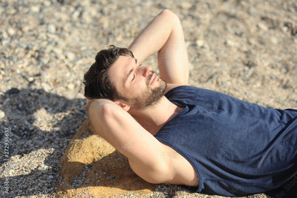 Young man portrait, relax on a sea beach
