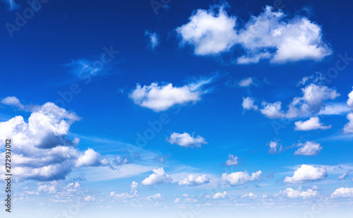 Beautiful blue sky background with sparced white clouds. Panorama. 