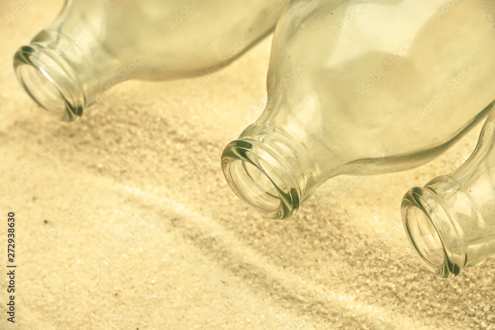 Three empty bottles glass on the beach,environment day concept. Three empty bottles glass on the beach,environment day concept.