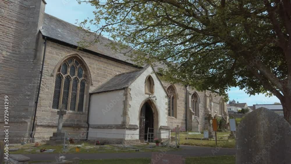 gimbal shot walking through graveyard approaching church gimbal shot walking through graveyard approaching church