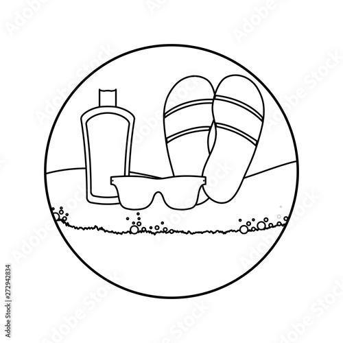 flip flops with sunglasses and bottle of blocker in beach