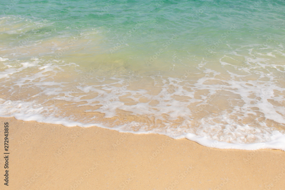 Close up of soft wave of ocean on the sand, background.