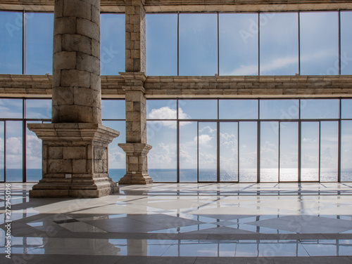 Empty lounge area with marble floorand view of a ocean and sky. photo