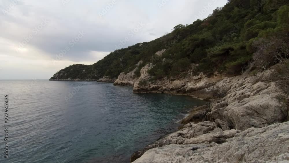 White stones rocky beach. Waves gently crashing to the shore. White stones rocky beach. Waves gently crashing to the shore.