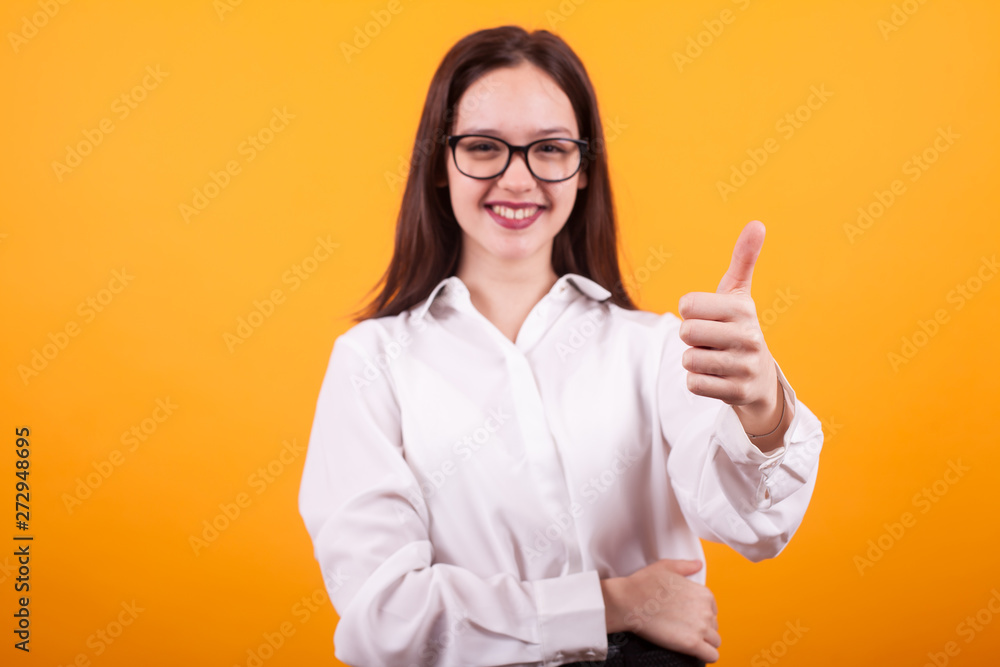Close up photo of blurred girl showing thumb up in studio Close up photo of blurred girl showing thumb up in studio
