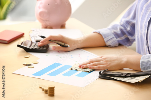 Young woman counting income...