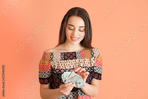 Happy young woman with doll...