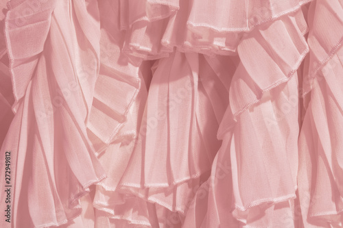 Amaranth pink color chiffon fabric folds. Rose dress with ruffles and frills. 