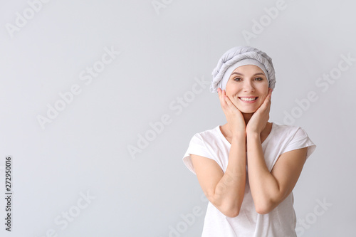 Woman after chemotherapy on light background