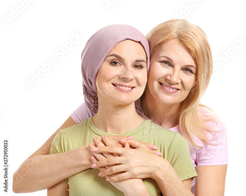 Woman after chemotherapy with her mother on white background