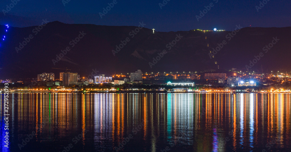 City by the sea and mountains at night