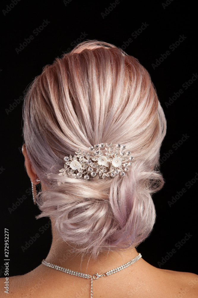 Back view of elegance hairstyle with vintage hair accessories over studio  background Stock Photo | Adobe Stock