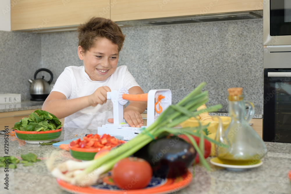 Child preparing lunch. Cutting carrots Child preparing lunch. Cutting carrots