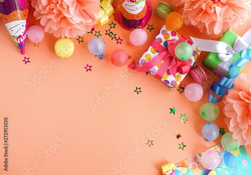 Party background top view.  Festive , birthday multicolored decorations on coral color background . Flat lay style. Copy space