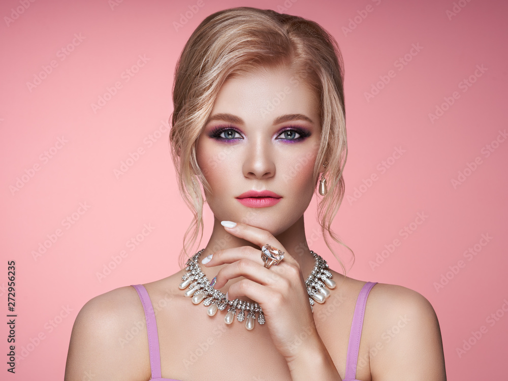 Portrait Beautiful Blonde Woman with Jewelry. Model Girl with Pearl Manicure on Nails. Elegant Hairstyle.  Beauty and Fashion Accessories. Perfect Make-Up. Pink Background