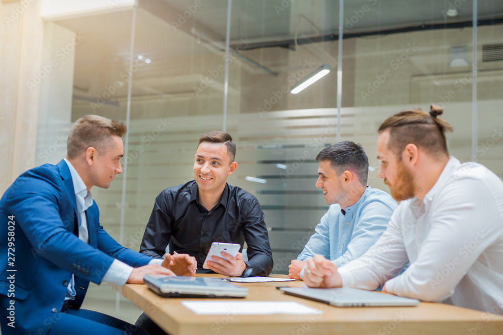 meeting of men entrepreneurs at the table in the office meeting of men entrepreneurs at the table in the office