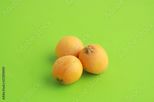 delicious yellow medlar fruit with colorful background photo