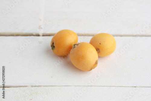 delicious yellow medlar fruit with wooden background