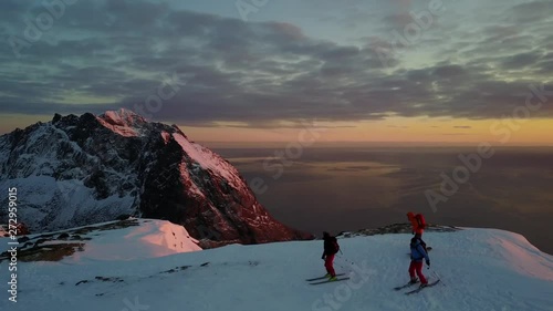 drone,follow cam of group of athletes,ski preparation on snow mountain top then going down the slope,avoiding some rocks along the way.extreme winter sports in norway.4K 30fps