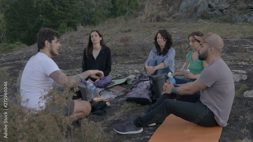 Five friends talking in the mountains at sunset. Some of them are drinking mate. Five friends talking in the mountains at sunset. Some of them are drinking mate.