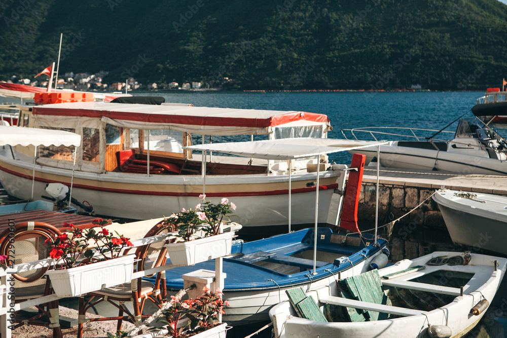 Many boats are moored at the shore. Sea transport.