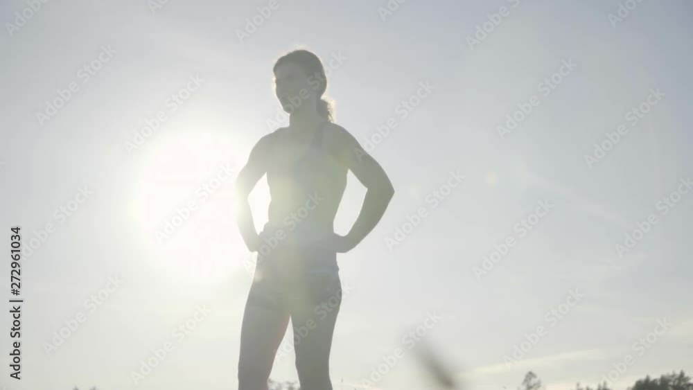 SLOMO of Young Woman Resting After a Run at Sunset SLOMO of Young Woman Resting After a Run at Sunset