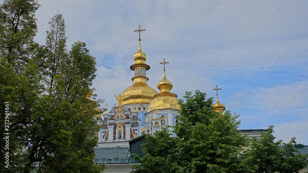 The dome of the St. Michael's Golden-domed cathedral among trees