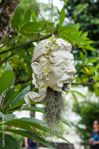 Scary masks hanging on trees at Wat Rong Khun - The White Temple
