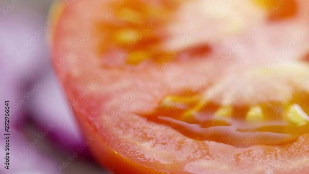 PAN shot with extreme close up of sliced tomato, red onions and cucumbers PAN shot with extreme close up of sliced tomato, red onions and cucumbers