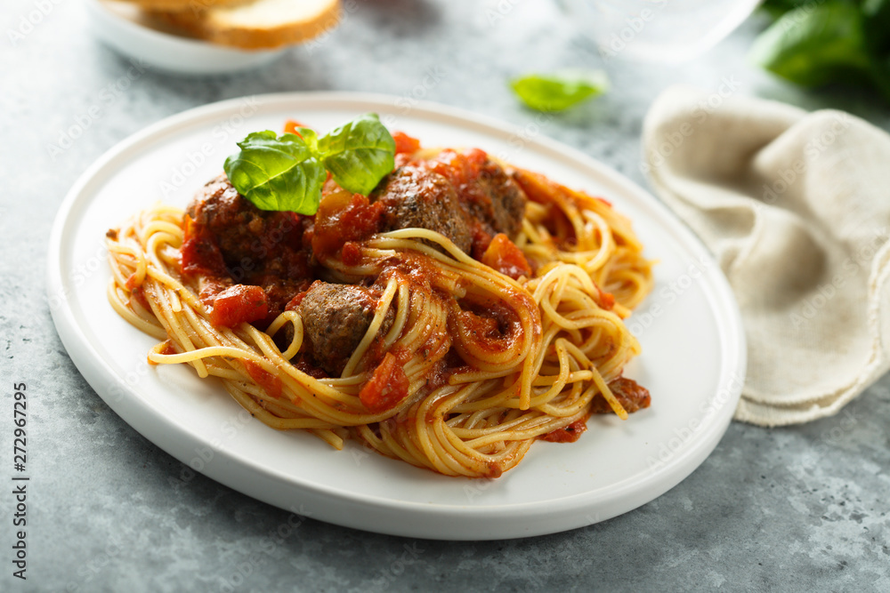 Pasta with meatballs, tomato sauce and basil