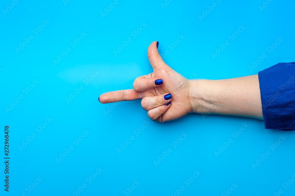 Female hand with dark blue nails showing gesture