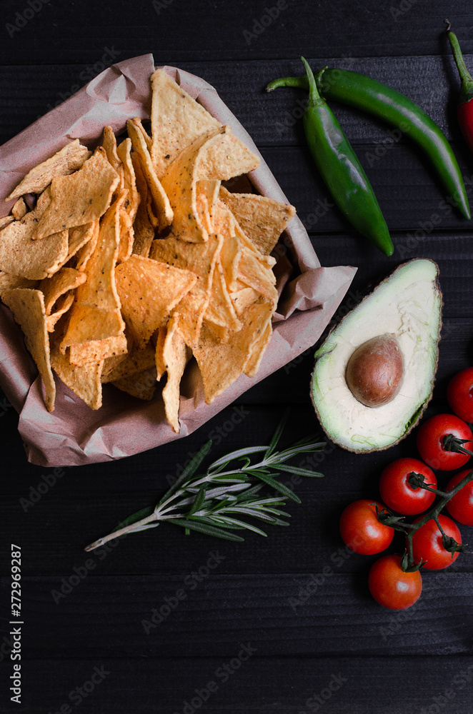 Mexican nachos with sauces on dark background Mexican nachos with sauces on dark background