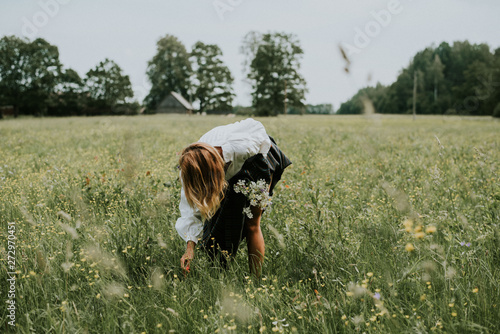 Folk girl in the midsummer making flower