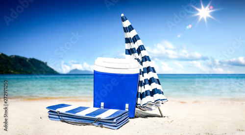 Summer background of beach with umbrella and ocean landscape. Sunny day and blue sky. 