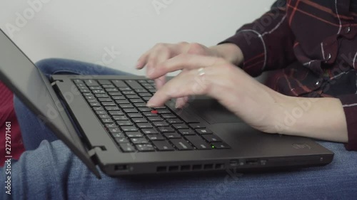 Caucasian female is using her laptop - closeup of her hands photo