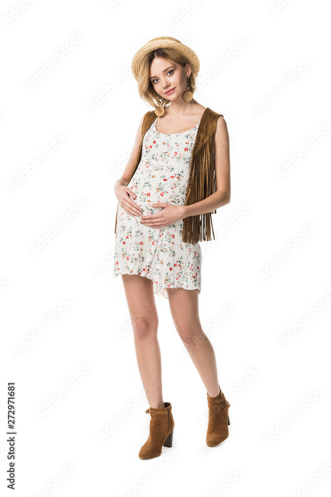 full length view of pregnant hippie girl in straw hat touching belly isolated on white full length view of pregnant hippie girl in straw hat touching belly isolated on white