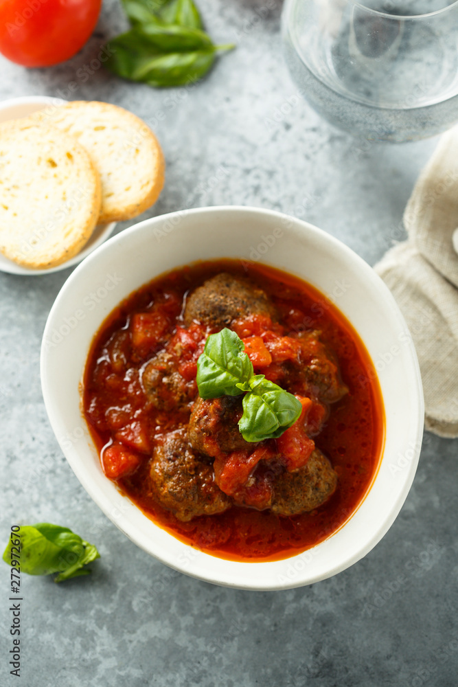 Homemade meatballs with tomato sauce and fresh basil Homemade meatballs with tomato sauce and fresh basil