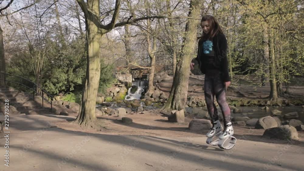 Fun new exercise workout with kangaroo shoes in the park Fun new exercise workout with kangaroo shoes in the park