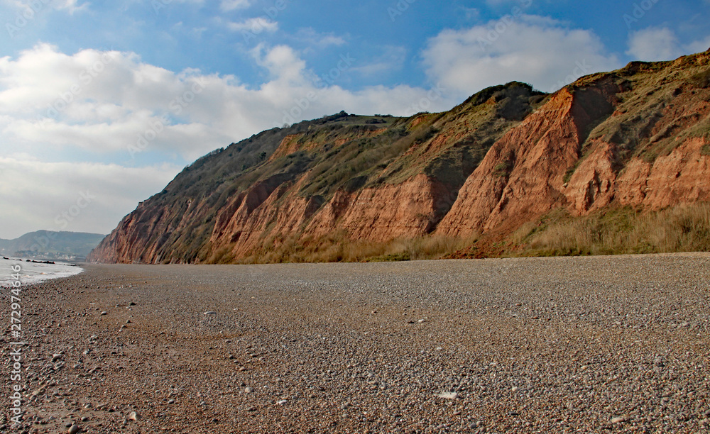 The sandstone cliffs of the Jurassic era rising from Salcombe Regis beach