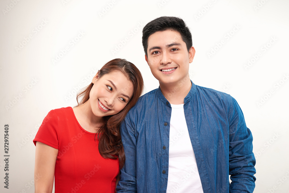 young asian couple leaning heads together over white background young asian couple leaning heads together over white background