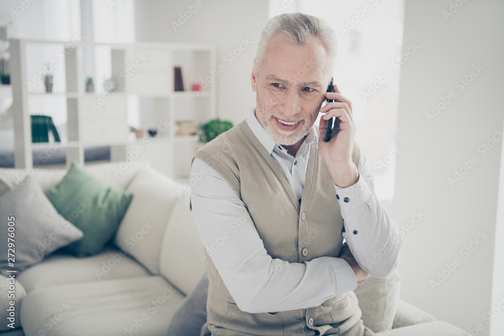 Close up photo amazing he him his aged man tell speak relatives children arms hands telephone wear white shirt waistcoat pants stand near cozy comfort divan bright flat house living room indoors Close up photo amazing he him his aged man tell speak relatives children arms hands telephone wear white shirt waistcoat pants stand near cozy comfort divan bright flat house living room indoors