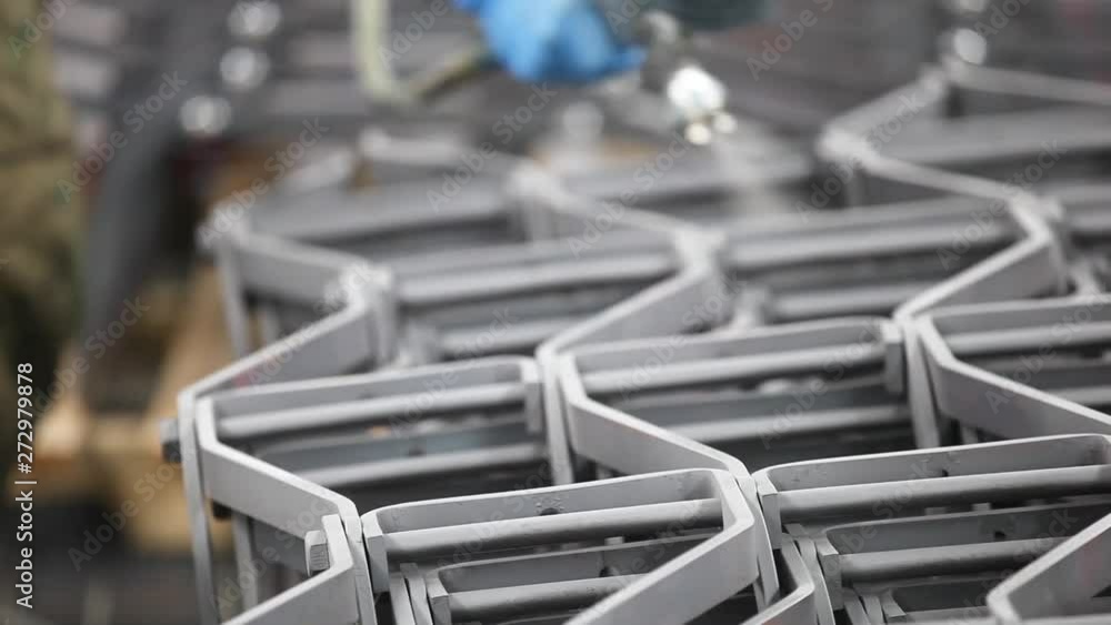 Close up of metal machine parts being sprayed. Close up of metal machine parts being sprayed.