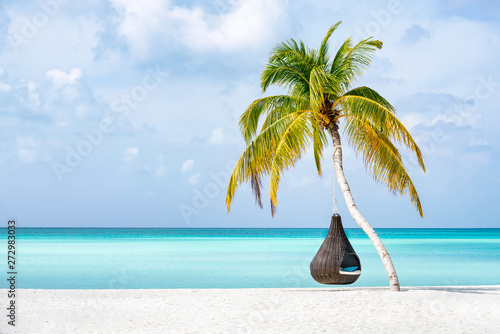 Fototapeta Naklejka Na Ścianę i Meble -  Hanging swing chair at a tropical beach