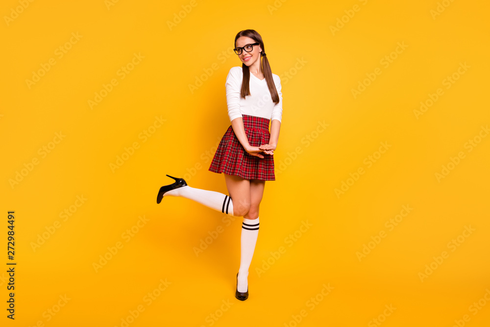 Full length body size view of her she nice attractive winsome lovely lovable cheerful cheery positive girl wearing uniform having fun isolated over bright vivid shine yellow background