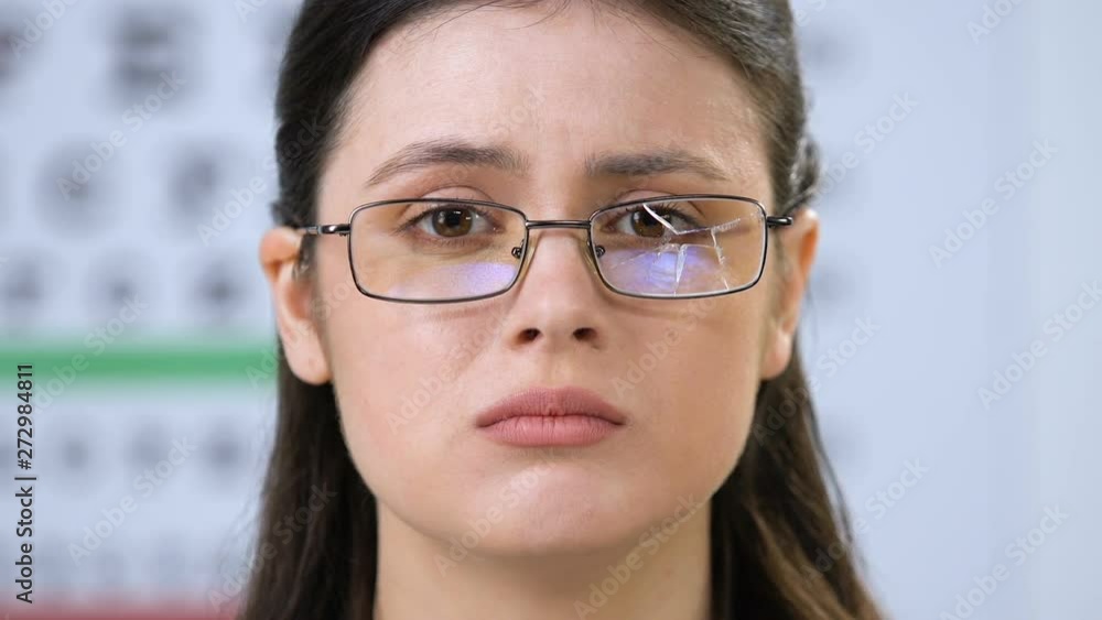 Upset woman with broken eyeglasses in optical shop, vision problems, health Upset woman with broken eyeglasses in optical shop, vision problems, health