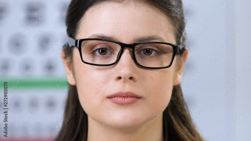Sales manager wearing glasses on smiling womans face, eyewear fitting, size Sales manager wearing glasses on smiling womans face, eyewear fitting, size