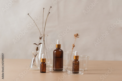 Cosmetic bottle stock images. Brown cosmetic bottle with batcher. Vials on a white background