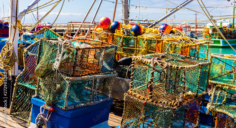 Crayfish nets and traps on a small fishing boat - obrazy, fototapety, plakaty 